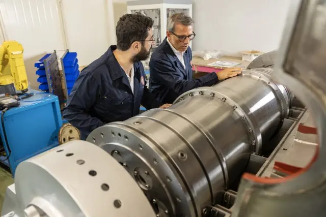 Rapanelli technicians inspecting a decanter centrifuge in the workshop